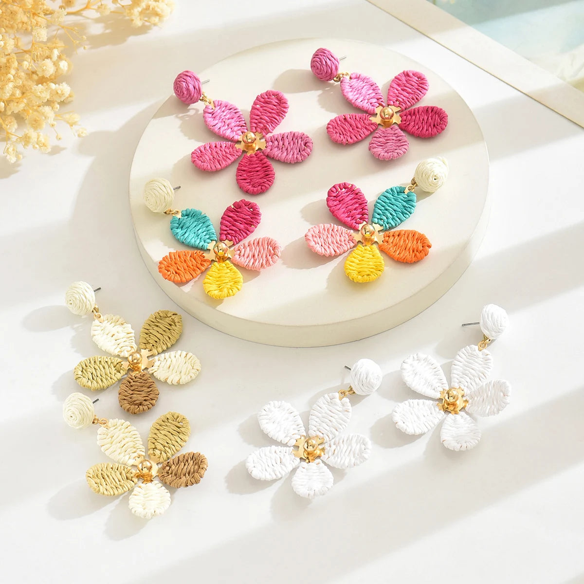 Bohemian-style hand-woven raffia flower earrings—a unique, minimalist design perfect for everyday wear.