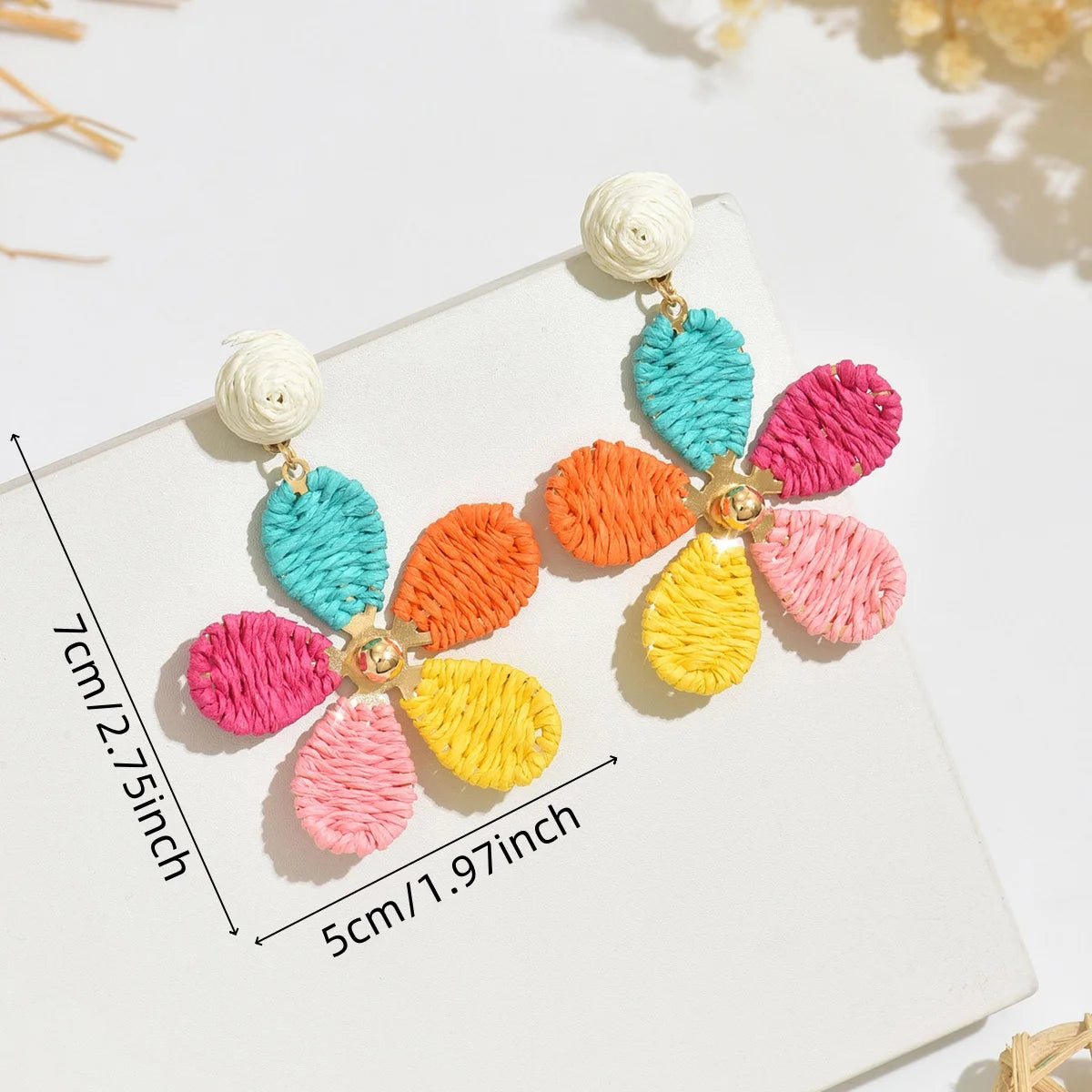Bohemian-style hand-woven raffia flower earrings—a unique, minimalist design perfect for everyday wear.