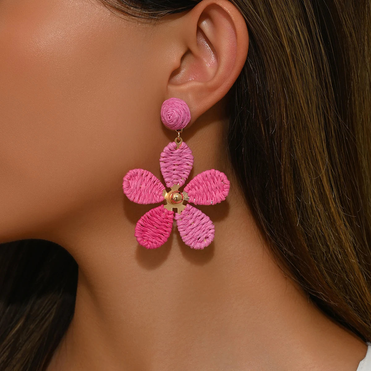 Bohemian-style hand-woven raffia flower earrings—a unique, minimalist design perfect for everyday wear.