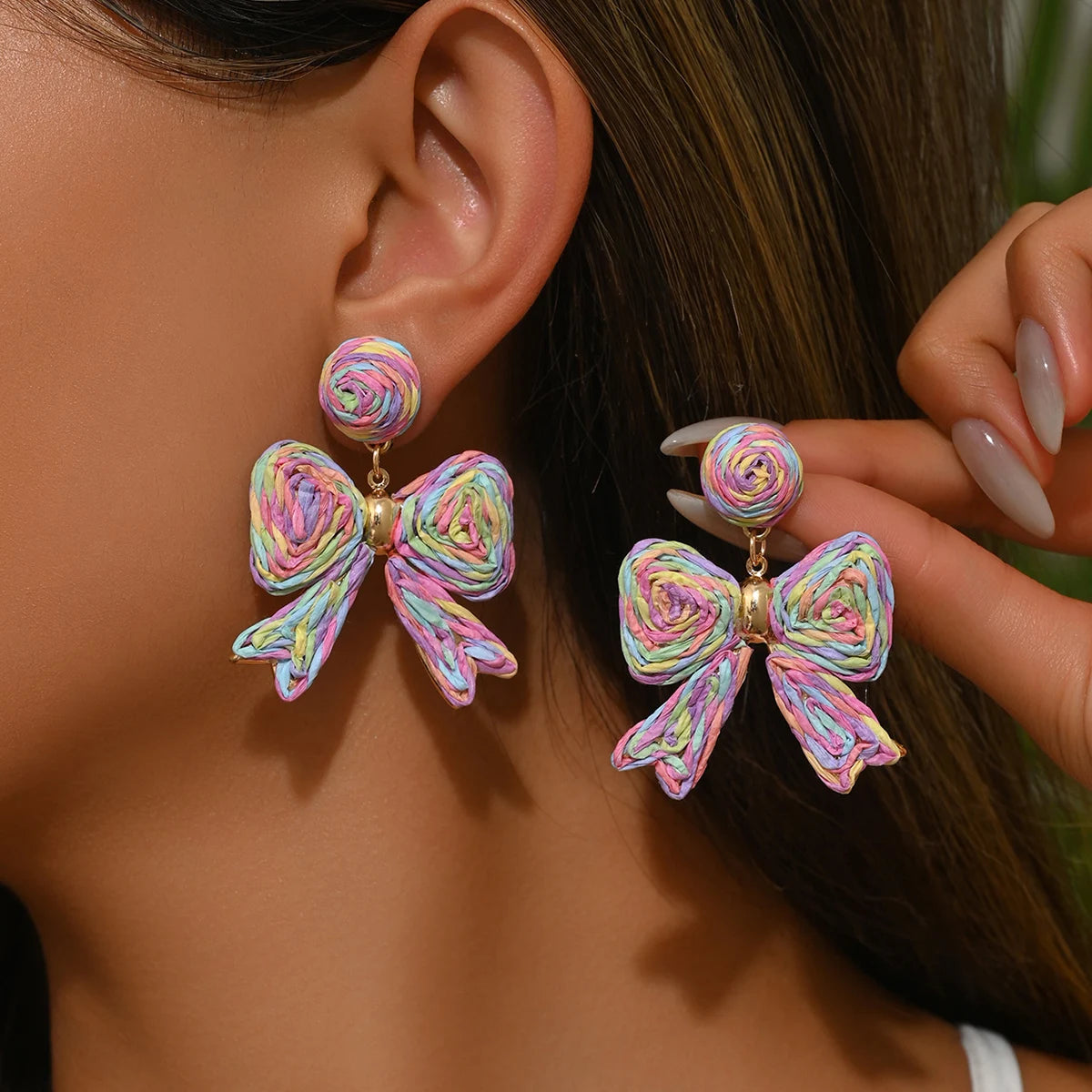 Handcrafted Bohemian-style raffia bow earrings, perfect for women to wear on vacation or for any occasion. They also make a wond