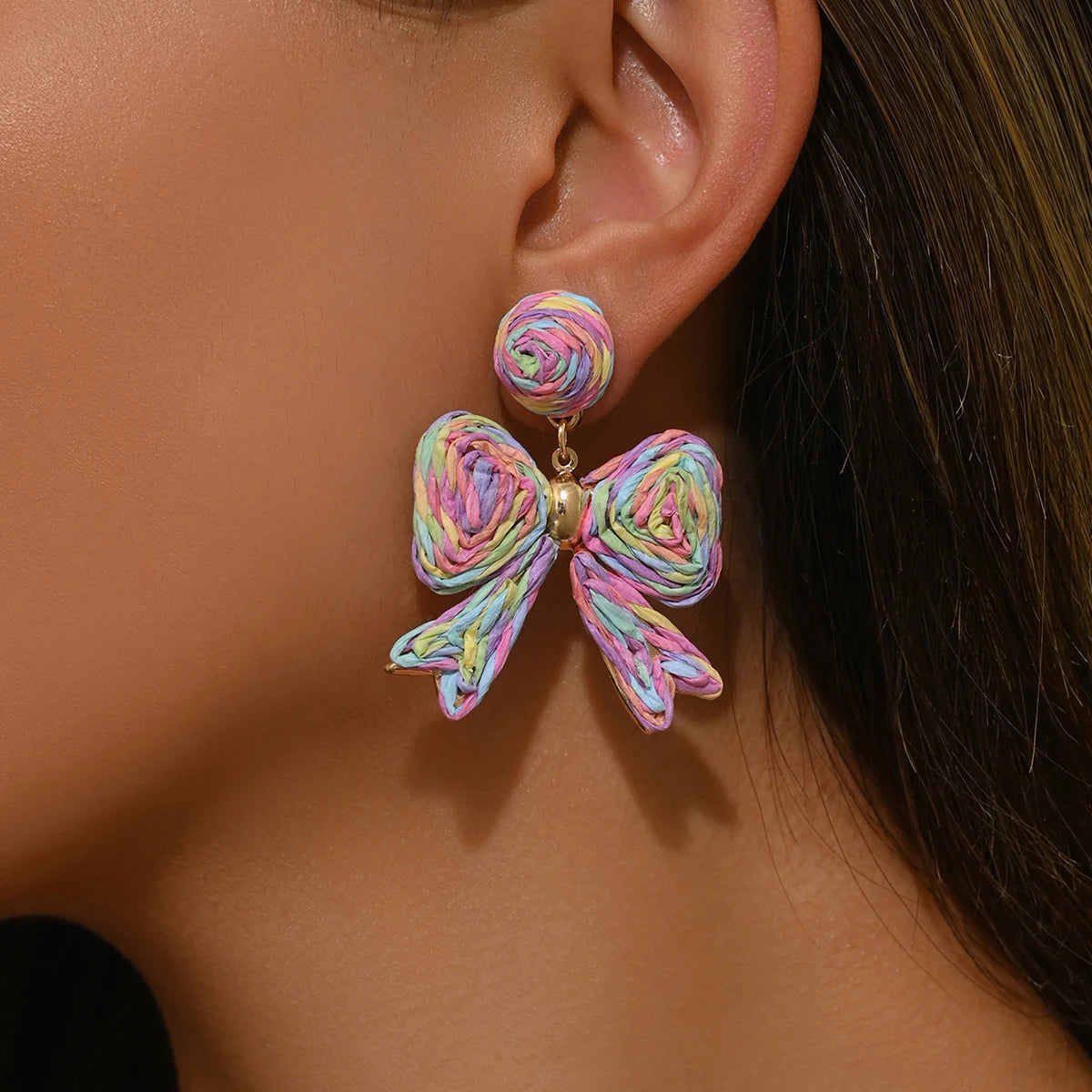 Handcrafted Bohemian-style raffia bow earrings, perfect for women to wear on vacation or for any occasion. They also make a wond